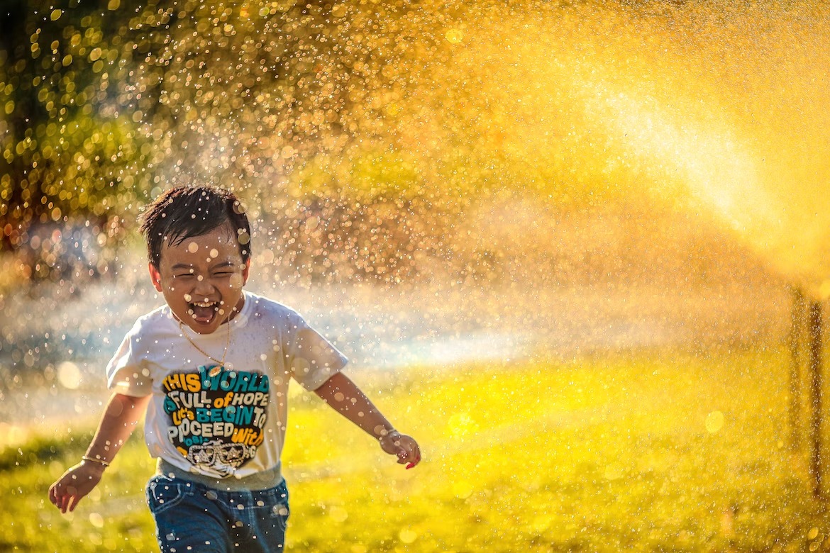 Young people splashing in water at a summer event